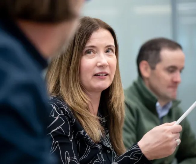 woman talking to men in a meeting